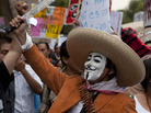 A man wearing a mask holds up a machete during a protest in May against a possible return of the old ruling Institutional Revolutionary Party in Mexico City. A man wearing a mask holds up a machete during a protest in May against a possible return of the old ruling Institutional Revolutionary Party in Mexico City.