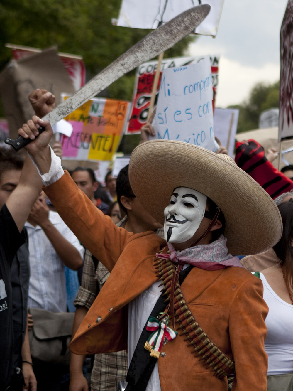 A man wearing a mask holds up a machete during a protest in May against a possible return of the old ruling Institutional Revolutionary Party in Mexico City.
