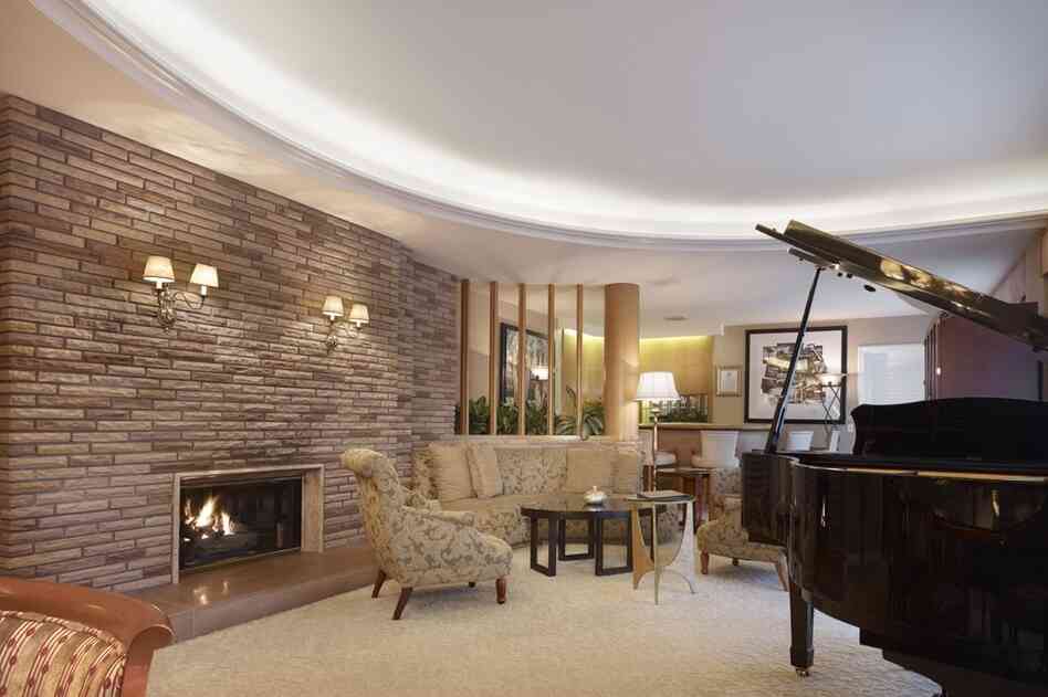 Another view of the Historic Paul Williams Suite. Originally designed in the late 1940s, the suite was moved to the second floor during a renovation in the 1990s, and re-created just as Williams designed it. It contains the same use of stone, curved walls and marble that are found in many of his permanent homes.