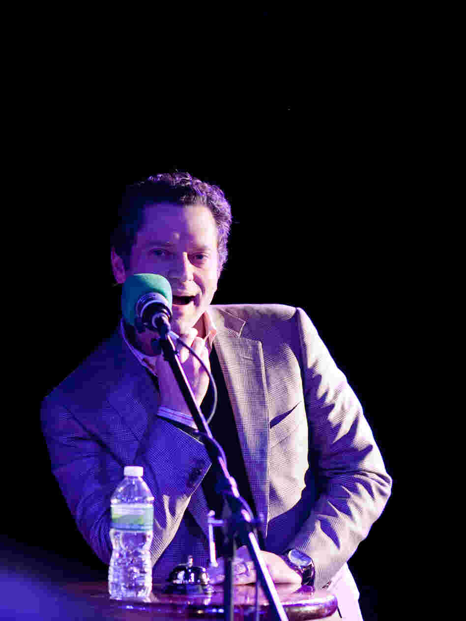 Sports journalist Jeremy Schaap in the hot seat on the Ask Me Another stage.