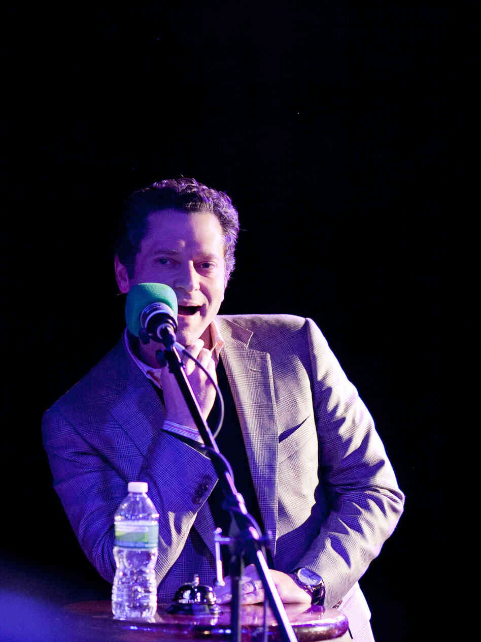 Sports journalist Jeremy Schaap in the hot seat on the Ask Me Another stage.