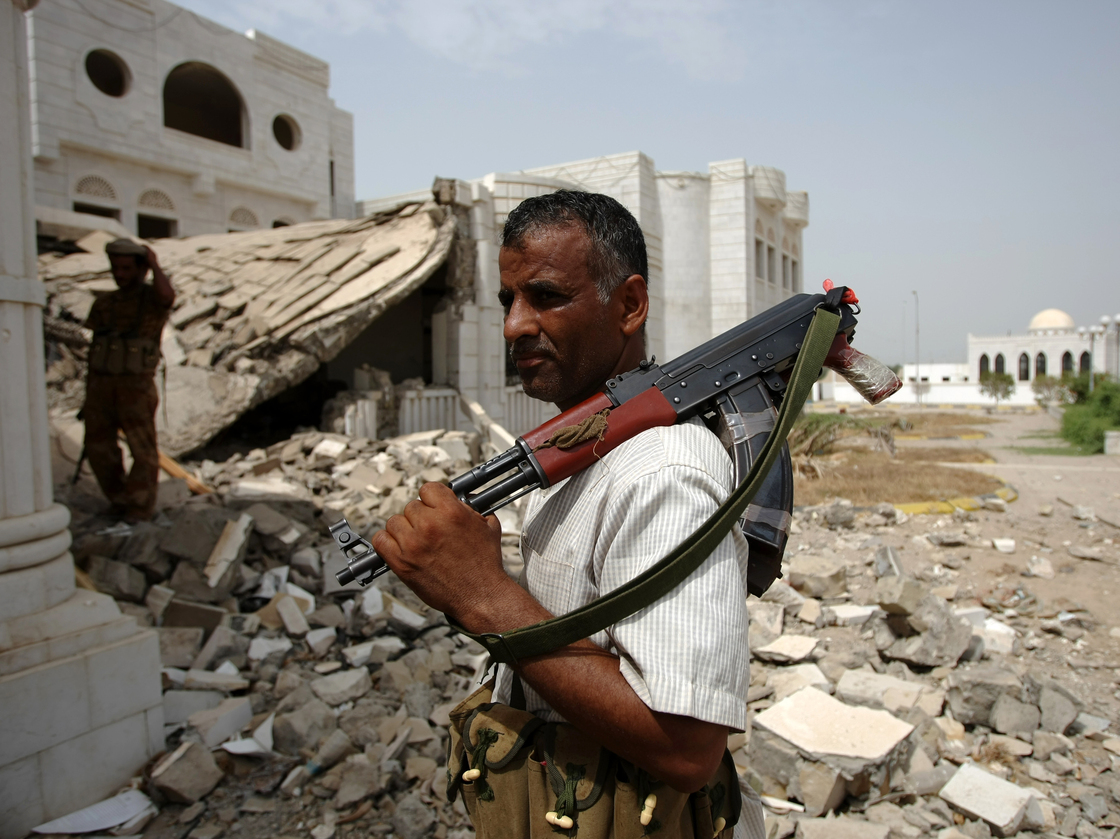 An armed Yemeni tribesman loyal to the army stands near a destroyed government building in the provincial capital of Zinjibar last week. The Yemeni military drove al-Qaida militants out of the city two days earlier.