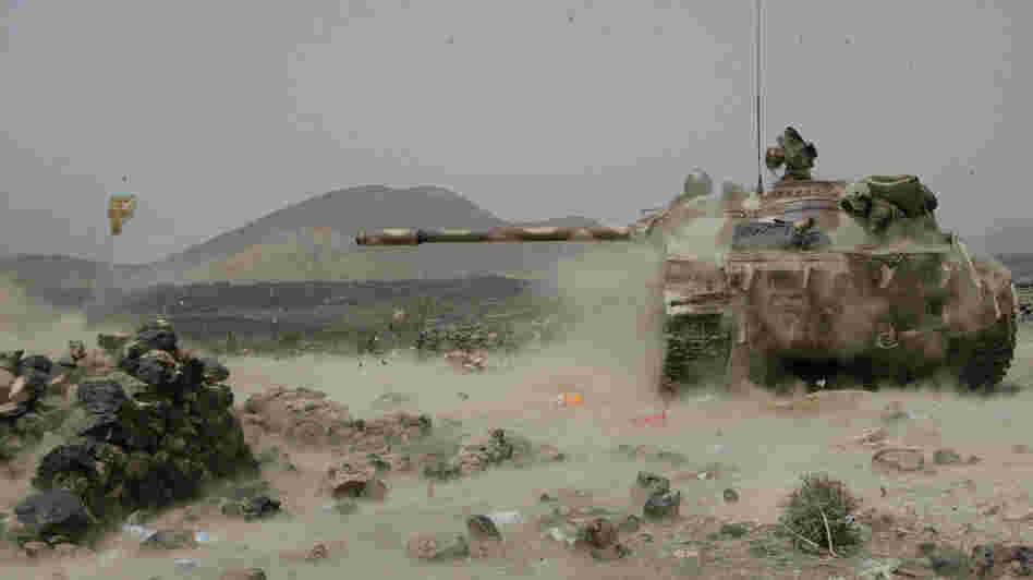 A Yemeni army tank fires at positions of al-Qaida militants near the coastal town of Shaqra, Yemen, last week, in a photo provided by Yemen's Defense Ministry. Yemen's army says it has pushed al-Qaida fighters out of towns in the south.