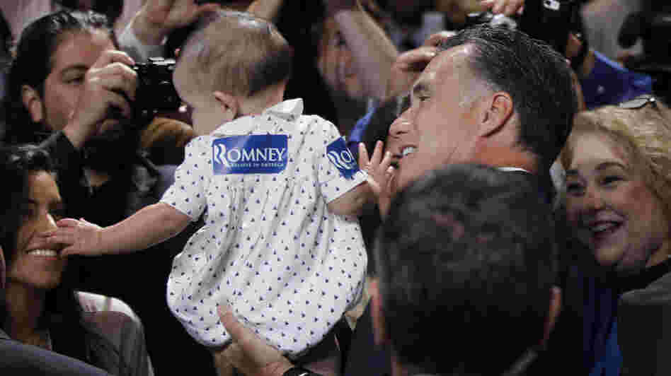 Republican presidential candidate Mitt Romney gives a young supporter a boost at the National Association of Latino Elected and Appointed Officials conference in Orlando, Fla., on Thursday.
