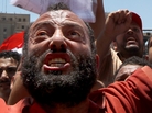 Supporters of the Muslim Brotherhood hold portraits of their candidate, Mohamed Morsi, as the they protest in Cairo's Tahrir square on June 21. Egypt was on edge after the Brotherhood declared an open-ended protest and warned of 'confrontation' unless their candidate is named president. Supporters of the Muslim Brotherhood hold portraits of their candidate, Mohamed Morsi, as the they protest in Cairo's Tahrir square on June 21. Egypt was on edge after the Brotherhood declared an open-ended protest and warned of 'confrontation' unless their candidate is named president.
