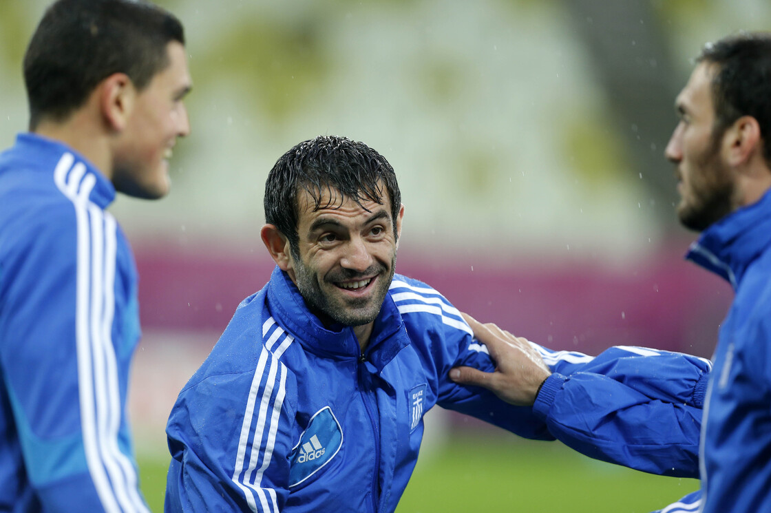 Greece's captain Giorgos Karagounis chats with his teammates during a training session, prior to the Euro 2012 soccer quarterfinal match between Germany and Greece in Poland.
