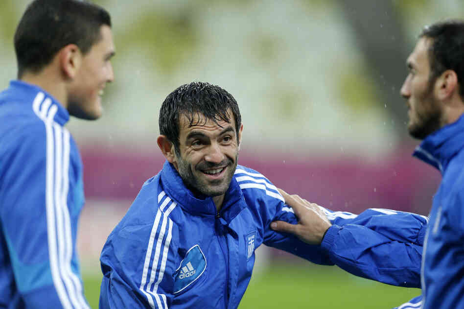 Greece's captain Giorgos Karagounis chats with his teammates during a training session, prior to the Euro 2012 soccer quarterfinal match between Germany and Greece in Poland.