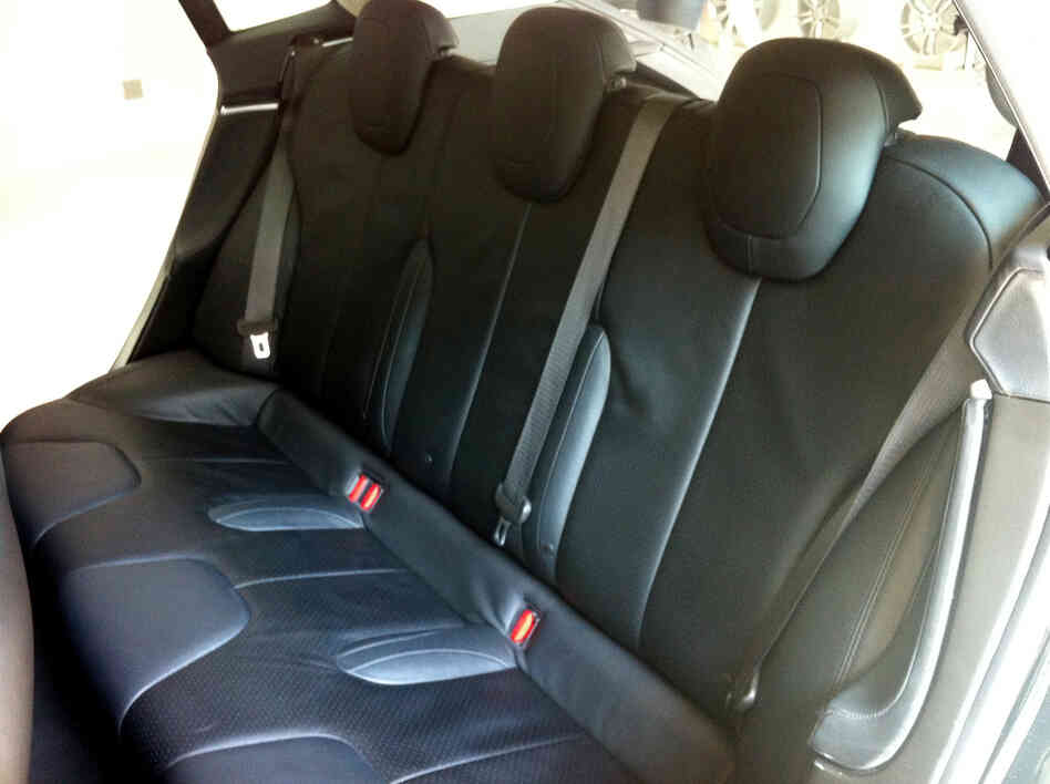The sedan's rear seats go three wide. With the seats folded flat, the car offers some 66 cubic feet of storage, according to Tesla.