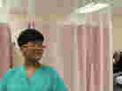 Certified Nurse Assistant Cynthia Johnson handles some of the intake at Highland Hospital's ER, featured in The Waiting Room.