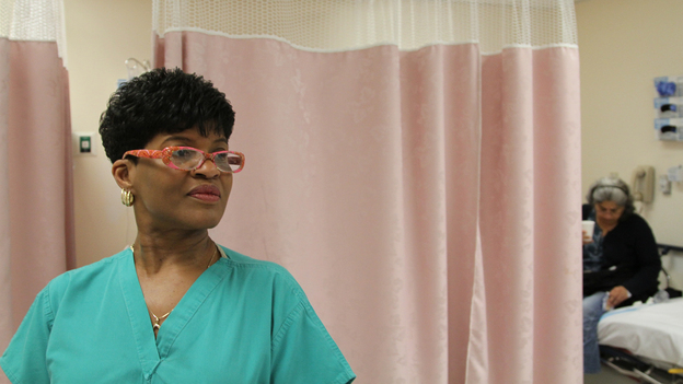 Certified Nurse Assistant Cynthia Johnson handles some of the intake at Highland Hospital's ER, featured in The Waiting Room.