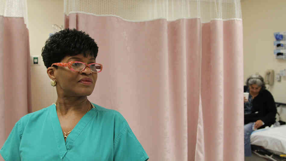 Certified Nurse Assistant Cynthia Johnson handles some of the intake at Highland Hospital's ER, featured in The Waiting Room.