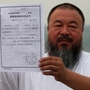 In a park in Beijing, Chinese artist Ai Weiwei holds a copy of a government document informing him of the expiry of his bail term. In a park in Beijing, Chinese artist Ai Weiwei holds a copy of a government document informing him of the expiry of his bail term.
