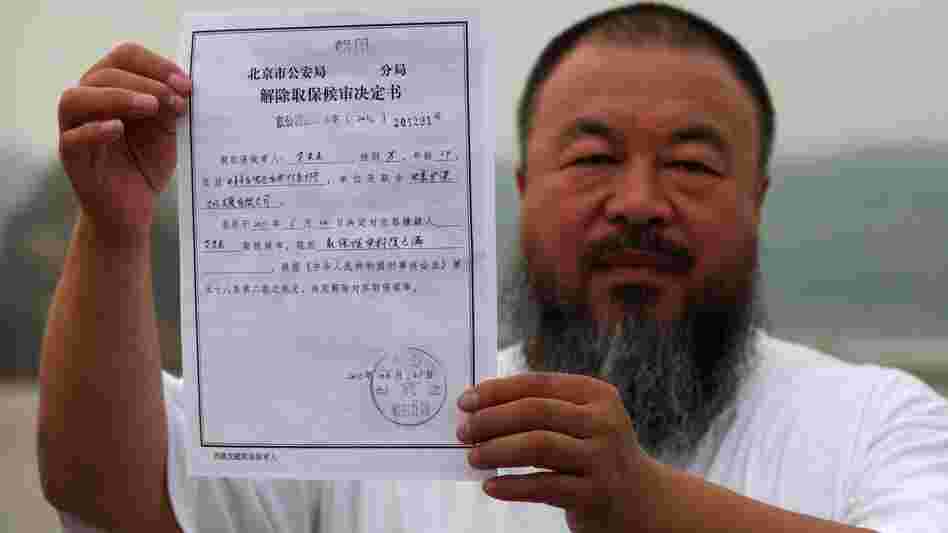 In a park in Beijing, Chinese artist Ai Weiwei holds a copy of a government document informing him of the expiry of his bail term. In a park in Beijing, Chinese artist Ai Weiwei holds a copy of a government document informing him of the expiry of his bail term.