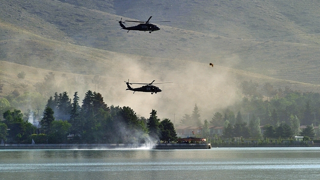 Responding to a Taliban attack, NATO Black Hawk helicopters fly over the Spozhmai Hotel on Lake Qargha outside Kabul. More than 20 people were killed before the Taliban fighters were shot dead. Responding to a Taliban attack, NATO Black Hawk helicopters fly over the Spozhmai Hotel on Lake Qargha outside Kabul. More than 20 people were killed before the Taliban fighters were shot dead.