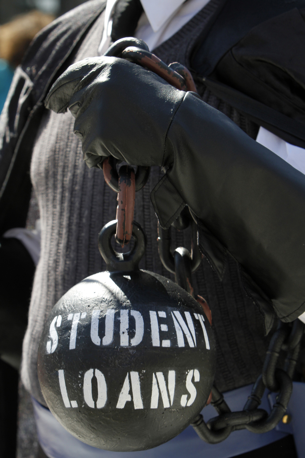 A demonstrator holds a ball and chain representing his college loan debt during an Occupy D.C. protest in Washington in October.
