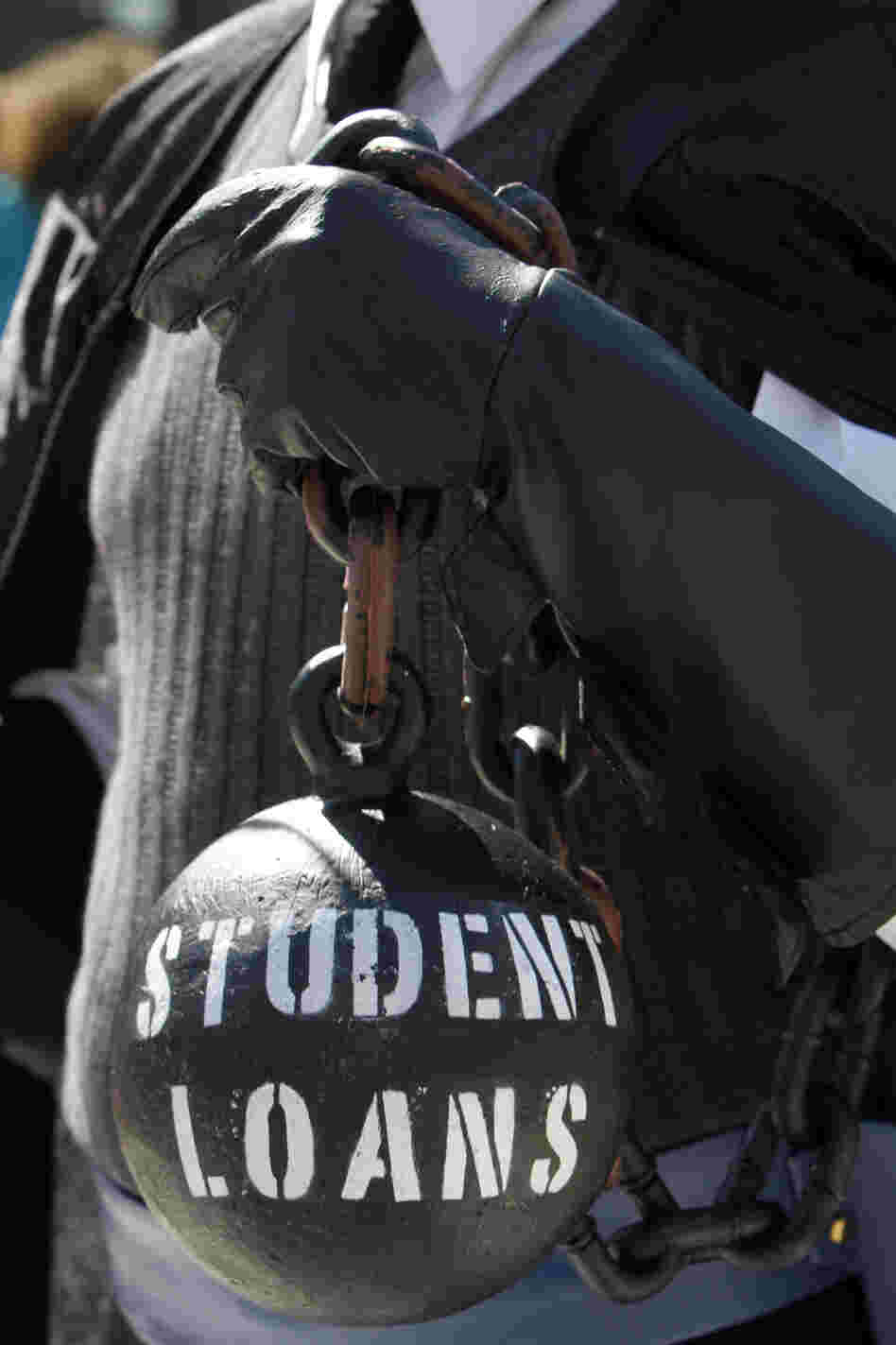 A demonstrator holds a ball and chain representing his college loan debt during an Occupy D.C. protest in Washington in October.