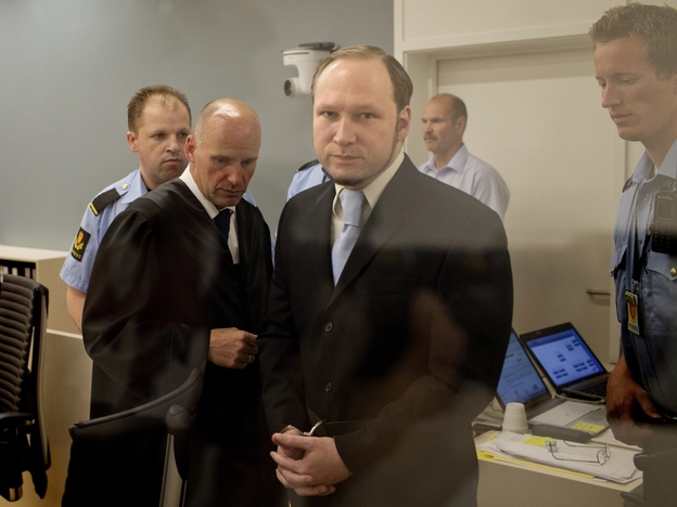 In this picture taken through bullet proof glass, mass killer Anders Behring Breivik looks on as he arrives for his trial in room 250 of Oslo's central court on June 21, 2012.