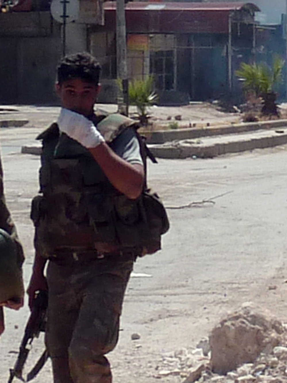 A Syrian soldier looks on as shooting takes place in the Damascus suburb of Douma last month. Sporadic fighting has been breaking out in and around the capital Damascus in recent weeks.
