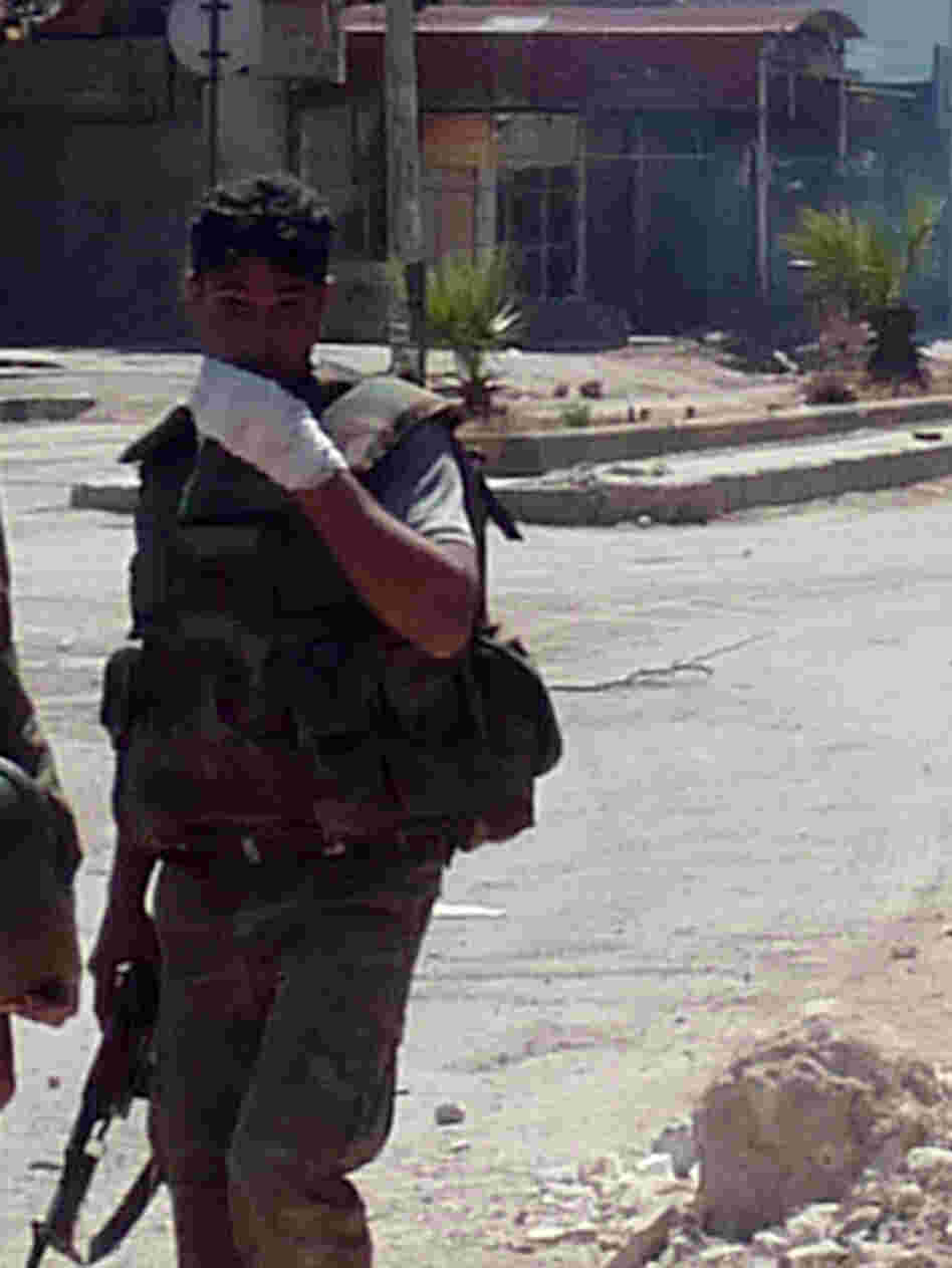 A Syrian soldier looks on as shooting takes place in the Damascus suburb of Douma last month. Sporadic fighting has been breaking out in and around the capital Damascus in recent weeks.