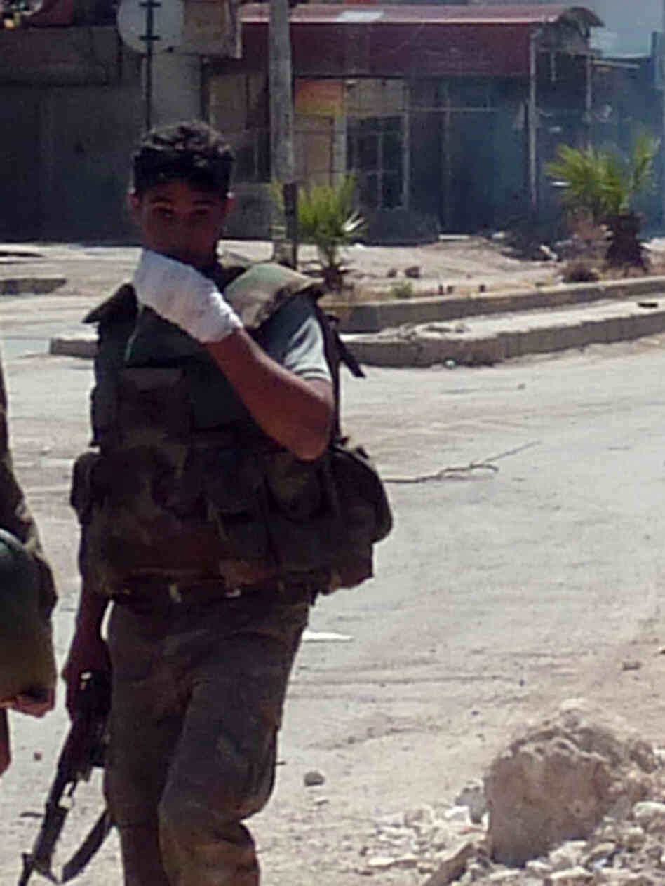 A Syrian soldier looks on as shooting takes place in the Damascus suburb of Douma last month. Sporadic fighting has been breaking out in and around the capital Damascus in recent weeks.