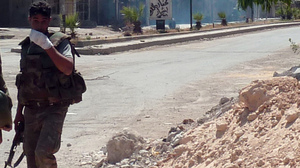 A Syrian soldier looks on as shooting takes place in the Damascus suburb of Douma last month. Sporadic fighting has been breaking out in and around the capital Damascus in recent weeks.