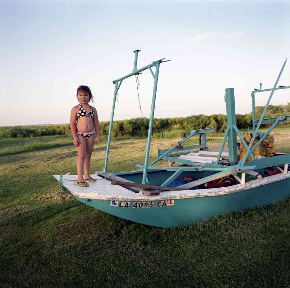 Kierstin Guidry with Hilton Chaisson's Boat, Isle de Jean Charles, Louisiana, 2010
