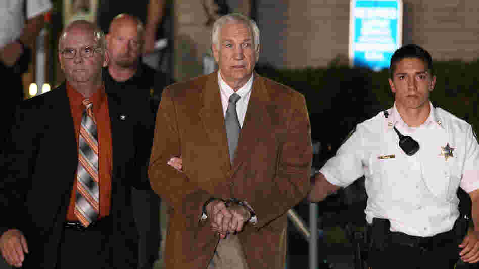 Former Penn State assistant football coach Jerry Sandusky leaves court in handcuffs Friday after being convicted in his child sex abuse trial at the Centre County Courthouse in Pennsylvania.