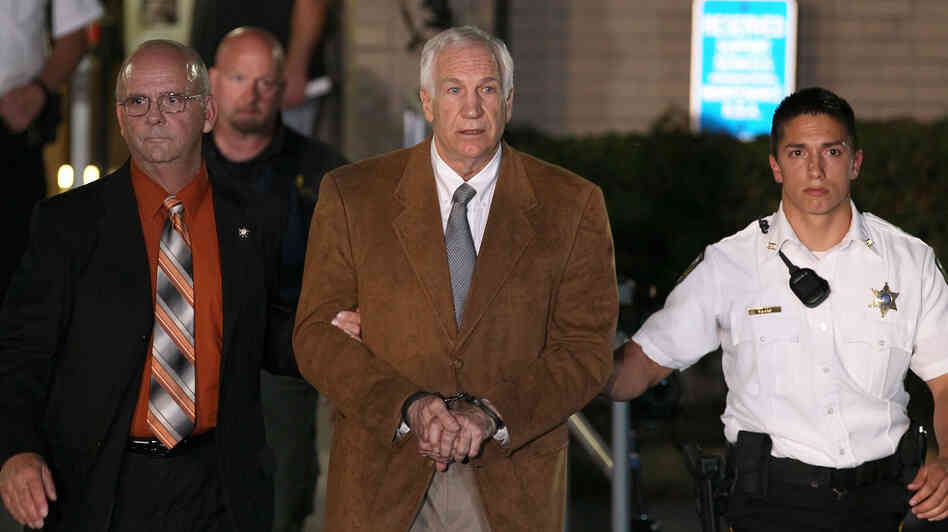 Former Penn State assistant football coach Jerry Sandusky leaves court in handcuffs Friday after being convicted in his child sex abuse trial at the Centre County Courthouse in Pennsylvania.