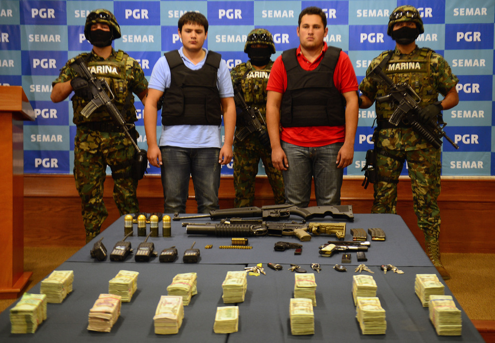 On Thursday, the Mexican Navy presented Felix Beltran Leon (in red) as the son of Joaquin "El Chapo" Guzman, Jesus Alfredo Guzman Salazar. On Friday, Mexican and U.S. officials confirmed that Beltran's identity had been mistaken.