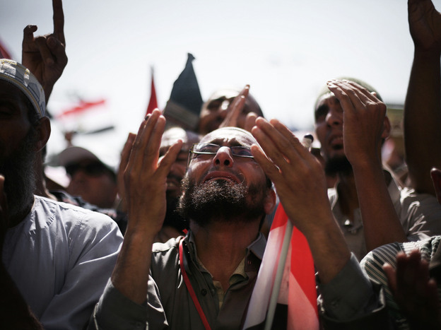 Egyptians raise their hands for prayer as they celebrate the victory of Mohammed Morsi in the presidential election in Tahrir square, Cairo, Egypt, Sunday.