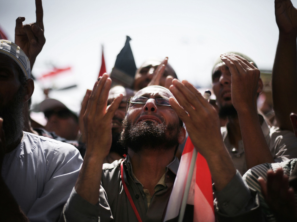Egyptians raise their hands for prayer as they celebrate the victory of Mohammed Morsi in the presidential election in Tahrir square, Cairo, Egypt, Sunday.