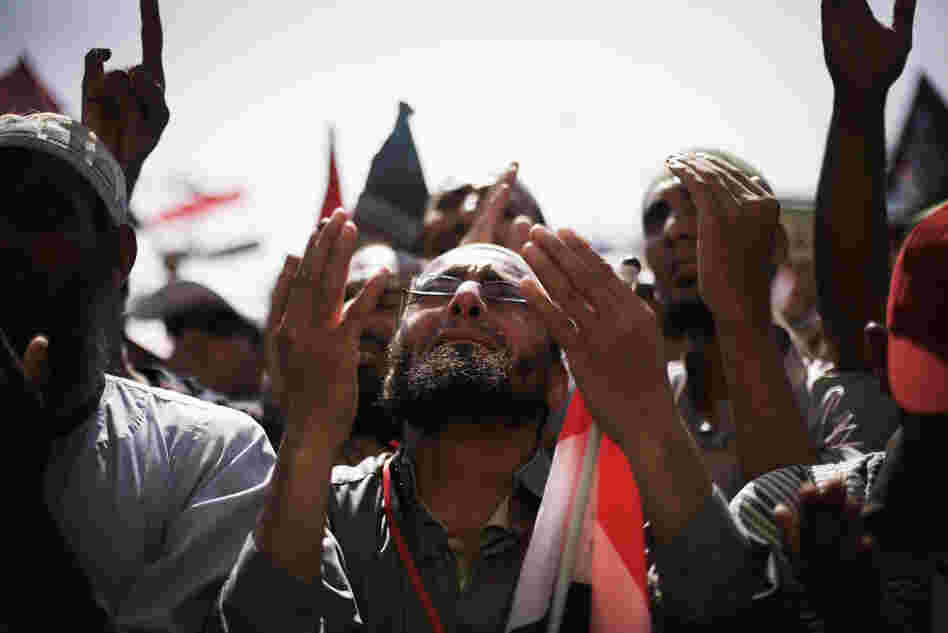 Egyptians raise their hands for prayer as they celebrate the victory of Mohammed Morsi in the presidential election in Tahrir square, Cairo, Egypt, Sunday.