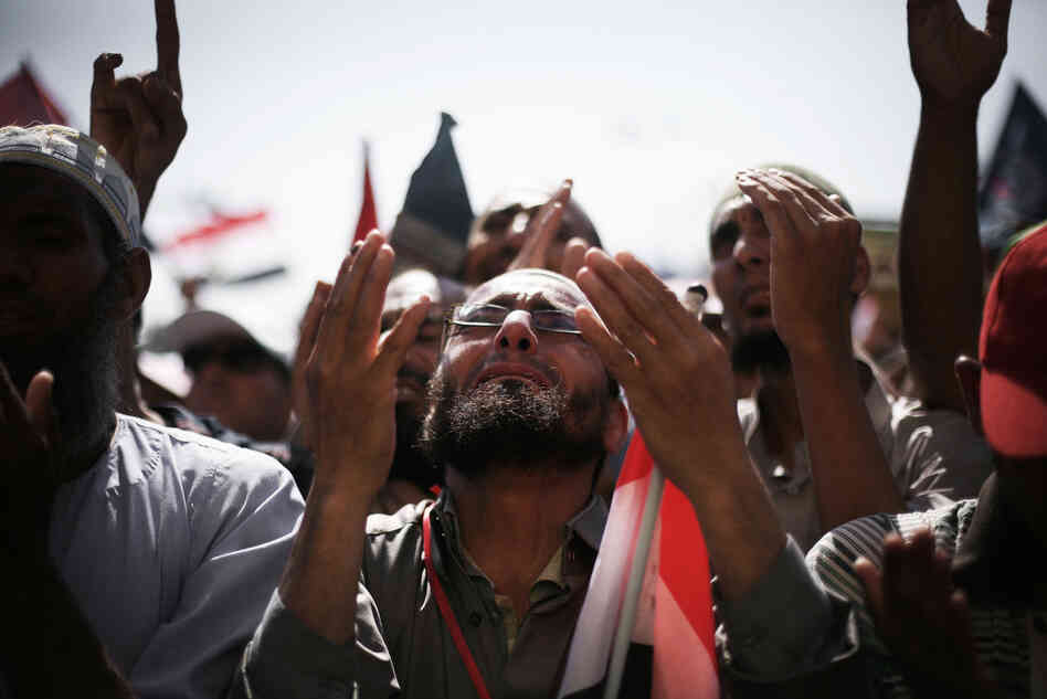 Egyptians raise their hands for prayer as they celebrate the victory of Mohammed Morsi in the presidential election in Tahrir square, Cairo, Egypt, Sunday.