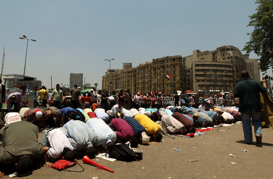 Egyptian supporters of their new president-elect, Muslim Brotherhood leader Mohamed Morsi, perform noon prayers in Cairo's Tahrir Square, one day after Morsi was elected as the country's "first civilian president" on Sunday.