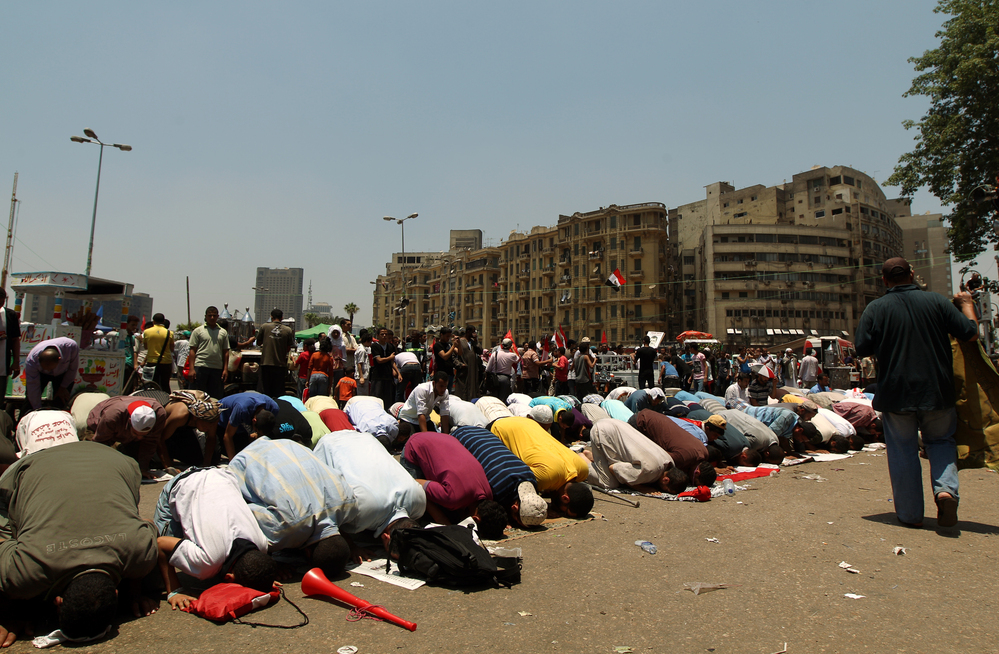 Egyptian supporters of their new president-elect, Muslim Brotherhood leader Mohamed Morsi, perform noon prayers in Cairo's Tahrir Square, one day after Morsi was elected as the country's "first civilian president" on Sunday.