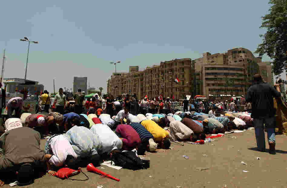 Egyptian supporters of their new president-elect, Muslim Brotherhood leader Mohamed Morsi, perform noon prayers in Cairo's Tahrir Square, one day after Morsi was elected as the country's "first civilian president" on Sunday.