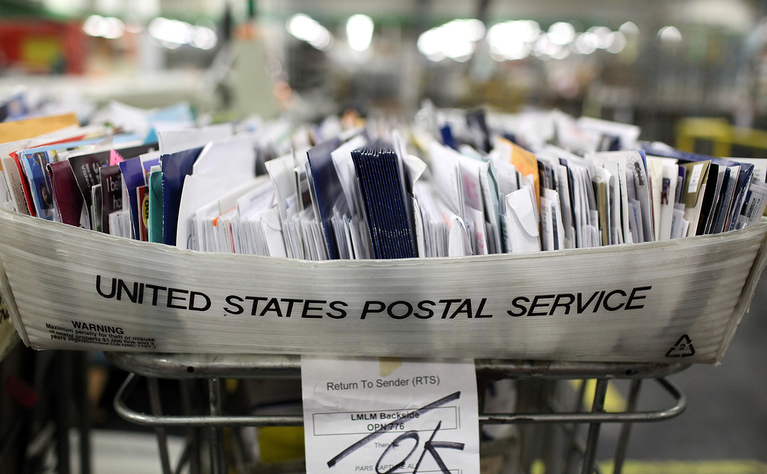 Cartons of mail ready to be sorted sit on a shelf at the U.S. Post Office sort center in San Francisco, California.