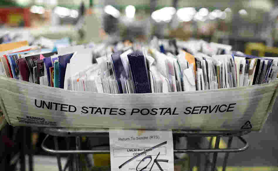 Cartons of mail ready to be sorted sit on a shelf at the U.S. Post Office sort center in San Francisco, California.