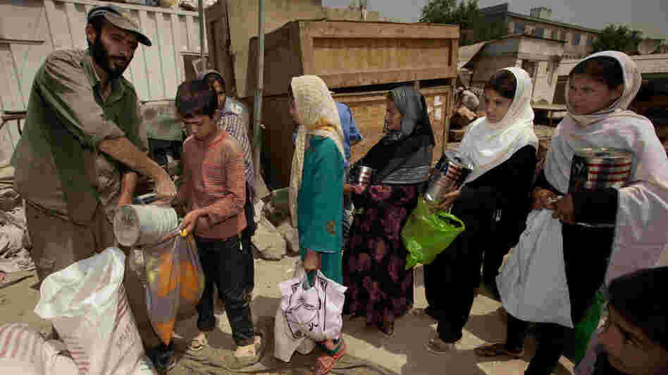 International aid has poured into Afghanistan in recent years, but it is expected to fall sharply as NATO forces pull out. That will place great strains on the economy, and may lead skilled Afghans to leave if they can't find work. Here, street children in Kabul collect food from an aid group. International aid has poured into Afghanistan in recent years, but it is expected to fall sharply as NATO forces pull out. That will place great strains on the economy, and may lead skilled Afghans to leave if they can't find work. Here, street children in Kabul collect food from an aid group.
