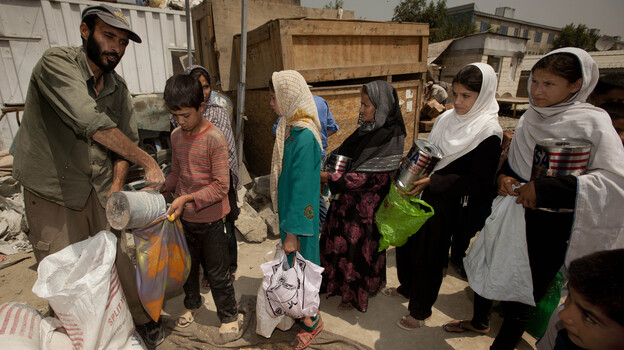 International aid has poured into Afghanistan in recent years, but it is expected to fall sharply as NATO forces pull out. That will place great strains on the economy, and may lead skilled Afghans to leave if they can't find work. Here, street children in Kabul collect food from an aid group. International aid has poured into Afghanistan in recent years, but it is expected to fall sharply as NATO forces pull out. That will place great strains on the economy, and may lead skilled Afghans to leave if they can't find work. Here, street children in Kabul collect food from an aid group.