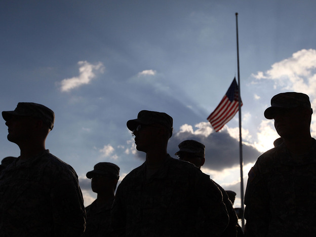 U.S. Army soldiers attend a Nov. 10, 2010, service for the 13 people killed in the shooting rampage five days earlier at Fort Hood.