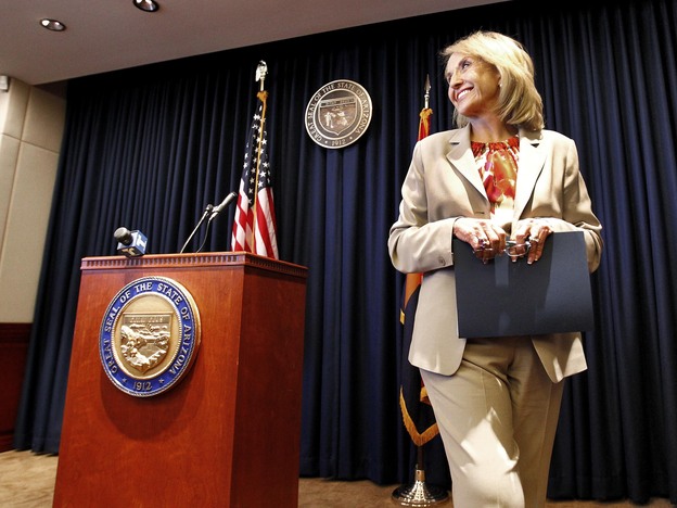 Arizona Republican Gov. Jan Brewer leaves a podium at the state Capitol in Phoenix after responding to President Obama's immigration speech on June 15. Brewer said the speech represented a "pre-emptive strike" aimed at what then was an upcoming Supreme Court ruling on Arizona's immigration law.