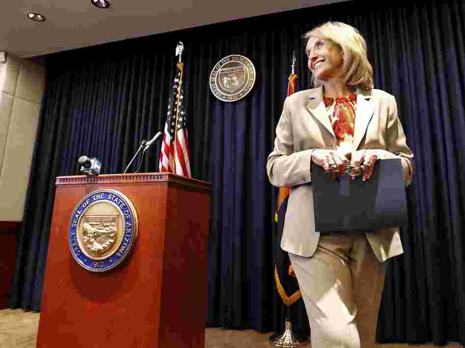 Arizona Republican Gov. Jan Brewer leaves a podium at the state Capitol in Phoenix after responding to President Obama's immigration speech on June 15. Brewer said the speech represented a "pre-emptive strike" aimed at what then was an upcoming Supreme Court ruling on Arizona's immigration law.