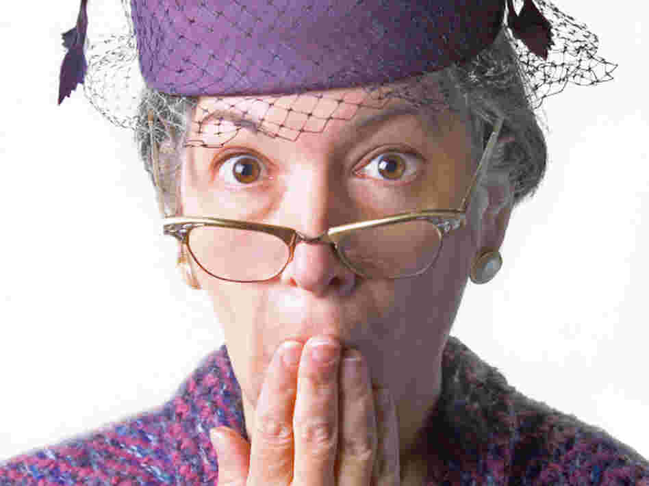 woman holding hand over mouth