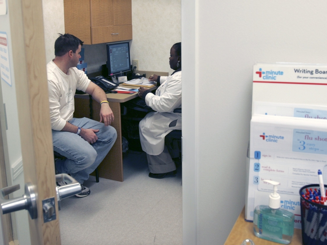 Shanda Johnson, right, a nurse practitioner, interviews patient Bill Gilligan at a MinuteClinic at the CVS drug store in North Brunswick, N.J.