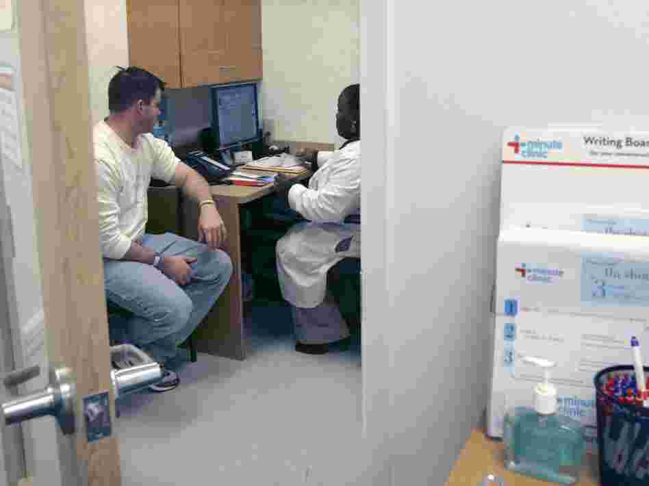 Shanda Johnson, right, a nurse practitioner, interviews patient Bill Gilligan at a MinuteClinic at the CVS drug store in North Brunswick, N.J.