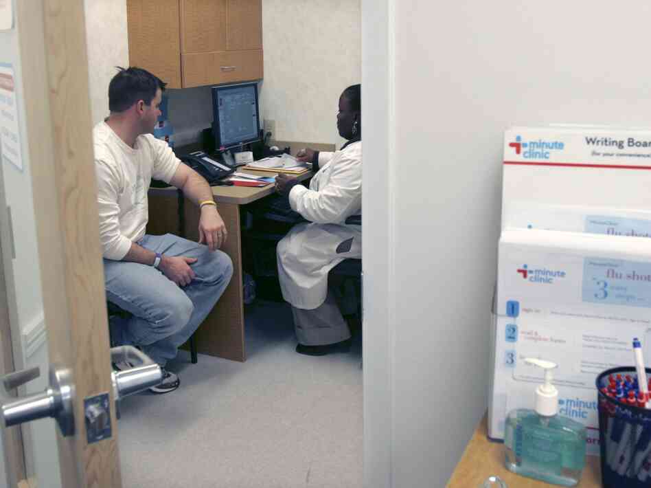 Shanda Johnson, right, a nurse practitioner, interviews patient Bill Gilligan at a MinuteClinic at the CVS drug store in North Brunswick, N.J.