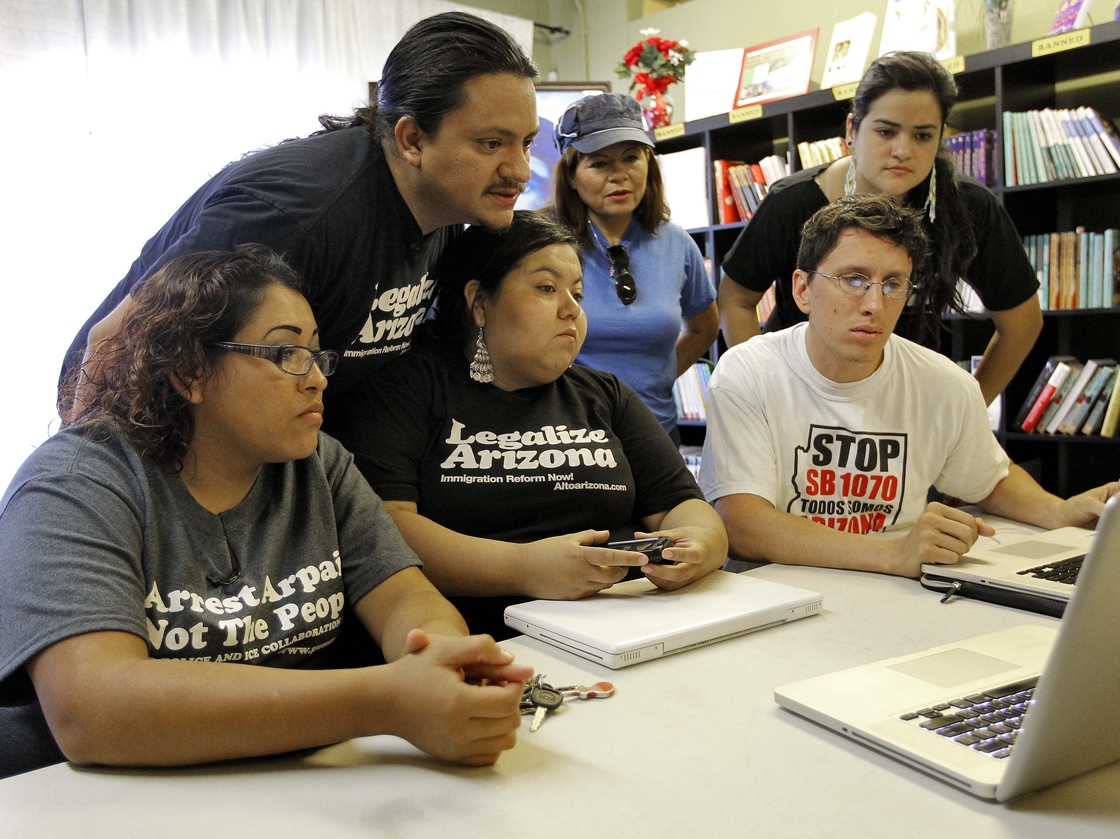 Members of the Puente Movement follow the Supreme Court's ruling on the Arizona immigration law from their office in Phoenix.