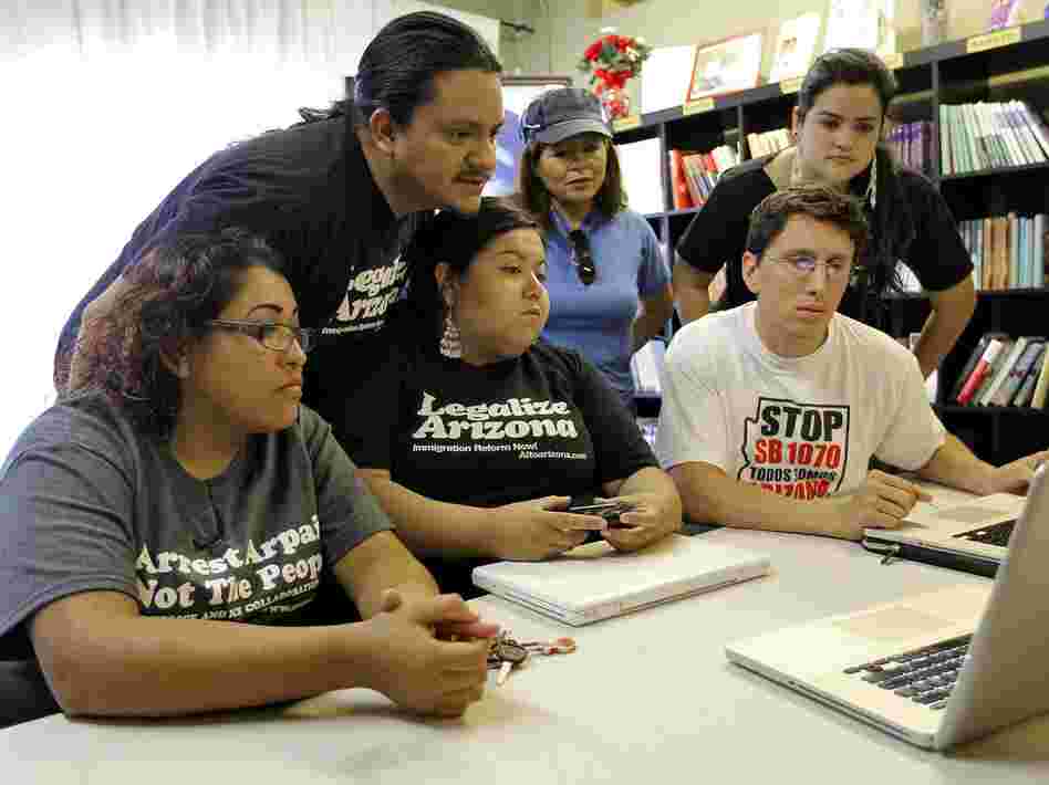 Members of the Puente Movement follow the Supreme Court's ruling on the Arizona immigration law from their office in Phoenix.