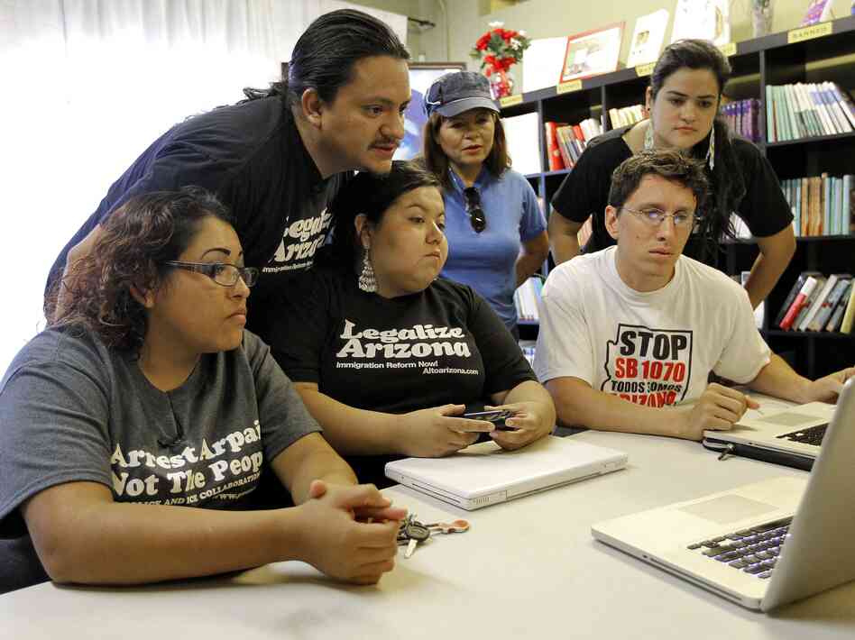 Members of the Puente Movement follow the Supreme Court's ruling on the Arizona immigration law from their office in Phoenix.